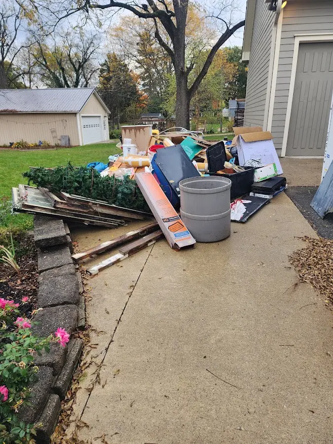 Dumpster being loaded with debris for Estate Cleanout Dumpster Rental in Minneola